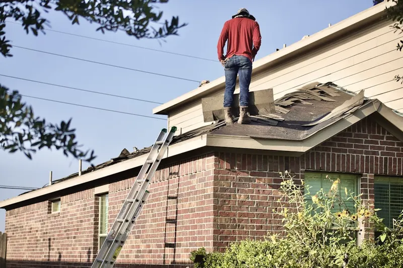 Professional roofer working on a residential roof in Handley